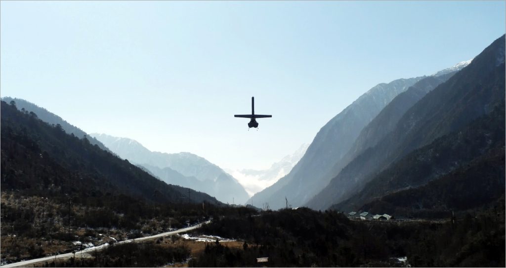 Unmanned aerial vehicle flying over mountainous terrain during defence surveillance operation